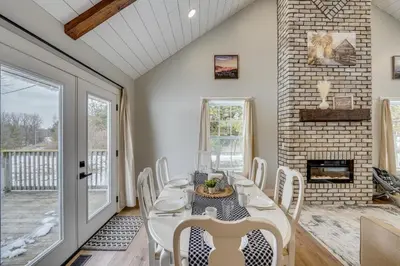 a dining room with a table and chairs and a fireplace at Willard Home On Working Farm with Water Views! in Willard