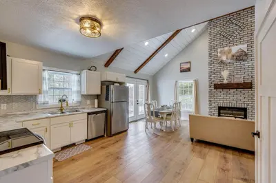 a kitchen and dining room with a table and refrigerator at Willard Home On Working Farm with Water Views! in Willard