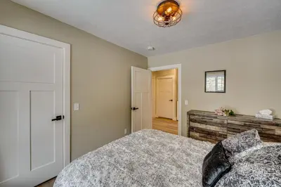 a bedroom with a bed and a wall at Willard Home On Working Farm with Water Views! in Willard