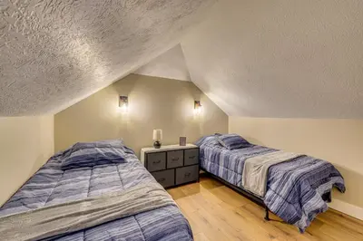 two beds in a attic room with two beds sidx sidx sidx at Willard Home On Working Farm with Water Views! in Willard