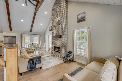 a living room with a fireplace and a brick wall at Willard Home On Working Farm with Water Views! in Willard