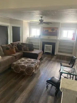 a living room with a couch and a chair at Rooms for Rent in Cleveland