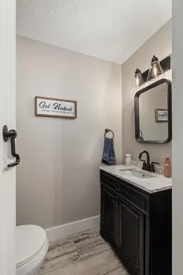 a bathroom with a sink and a mirror at Historic Farmhouse with Pool & Barn in Mansfield