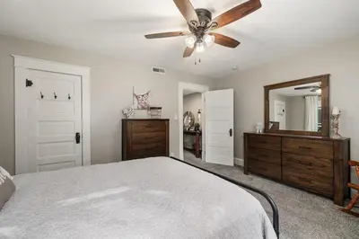 a bedroom with a bed and a ceiling fan at Historic Farmhouse with Pool & Barn in Mansfield