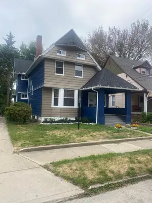 a house with a blue and brown house at 1469 east 116th in Cleveland