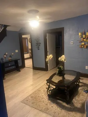 a living room with a table with flowers on it at 1469 east 116th in Cleveland