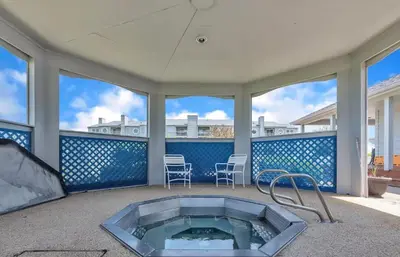 a hot tub on a patio with two chairs at Port Clinton Paradise- Waterfront 2 bedroom, Pool, Hot tub, Sauna, Fire pit in Port Clinton