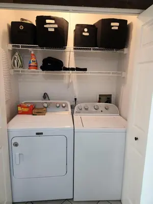 a kitchen with two washers and a dryer at Port Clinton Paradise- Waterfront 2 bedroom, Pool, Hot tub, Sauna, Fire pit in Port Clinton