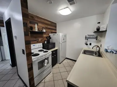 a kitchen with a white stove and a refrigerator at Port Clinton Paradise- Waterfront 2 bedroom, Pool, Hot tub, Sauna, Fire pit in Port Clinton