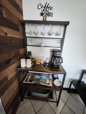a coffee shop with a table with a coffee bar at Port Clinton Paradise- Waterfront 2 bedroom, Pool, Hot tub, Sauna, Fire pit in Port Clinton