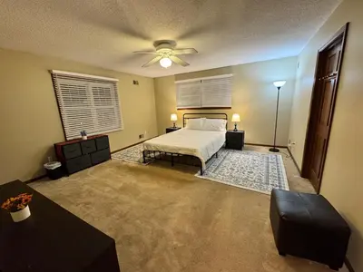 a bedroom with a bed and a ceiling fan at Luxury 5BR Estate: Media Room & Golf | Sleeps 14 in Sylvania