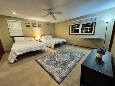 a bedroom with two beds and a rug at Luxury 5BR Estate: Media Room & Golf | Sleeps 14 in Sylvania