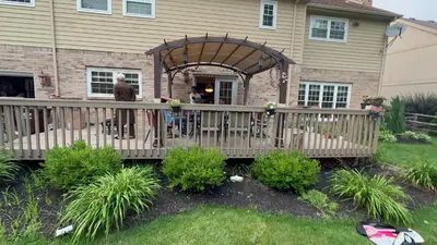 a man standing on a wooden deck in front of a house at Luxury 5BR Estate: Media Room & Golf | Sleeps 14 in Sylvania