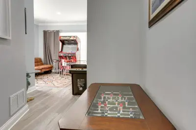 a living room with a chessboard on a table at 7 Mi to Cedar Point Retreat with Hot Tub and Gazebo in Huron