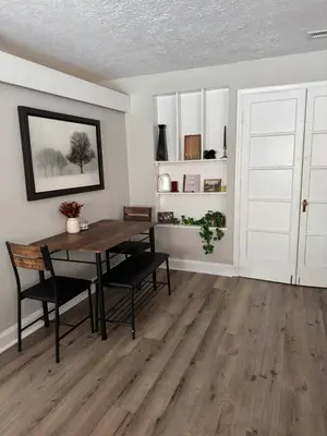 a dining room with a table and chairs at The Cozy Cottonwood Cottage- Clintonville 3BRM Ranch in Columbus