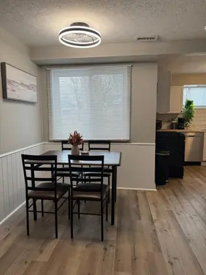 a dining room with a table and chairs at The Cozy Cottonwood Cottage- Clintonville 3BRM Ranch in Columbus