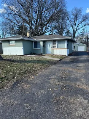 a blue house with a driveway in front of it at The Cozy Cottonwood Cottage- Clintonville 3BRM Ranch in Columbus