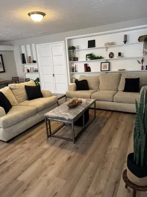 a living room with two couches and a table at The Cozy Cottonwood Cottage- Clintonville 3BRM Ranch in Columbus