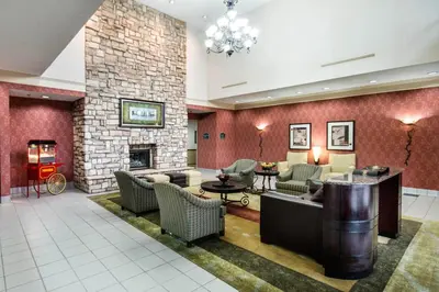 a lobby with couches and a fireplace at River Bluff Hotel and Conference Center in Mineralwells