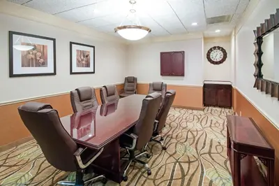 a conference room with a table and chairs at River Bluff Hotel and Conference Center in Mineralwells