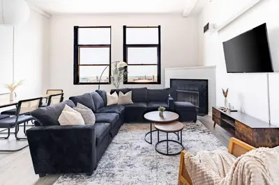 a living room with a couch and a fireplace at CLE Large Loft/Wolstein/Progressive/Playhouse/CSU in Cleveland