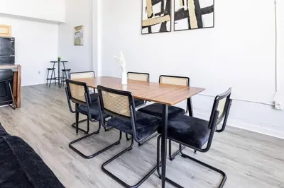 a dining room with a wooden table and chairs at CLE Large Loft/Wolstein/Progressive/Playhouse/CSU in Cleveland