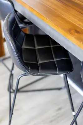 a black chair sitting under a wooden table at CLE Large Loft/Wolstein/Progressive/Playhouse/CSU in Cleveland