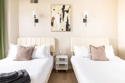 two beds sitting next to each other in a bedroom at Downtown 2BR | Walk to Venues, Play house Square in Cleveland