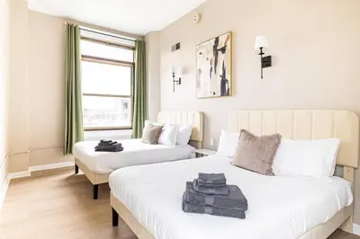 a bedroom with two beds and a window at Downtown 2BR | Walk to Venues, Play house Square in Cleveland