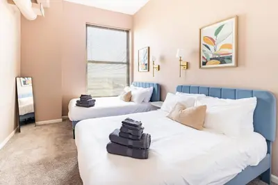 a bedroom with two beds and a window at Cleveland Loft/Wolstein/Progressive/Playhouse/CSU in Cleveland