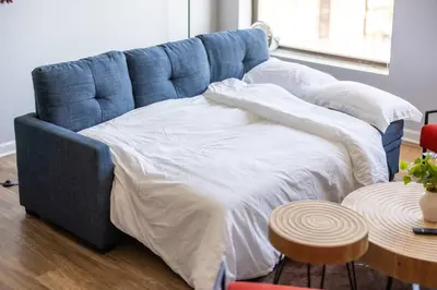 a blue bed in a room with a table at Cleveland Loft/Wolstein/Progressive/Playhouse/CSU in Cleveland