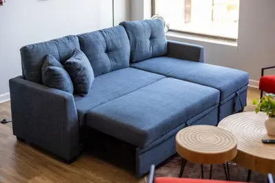 a blue couch in a living room with a table at Cleveland Loft/Wolstein/Progressive/Playhouse/CSU in Cleveland