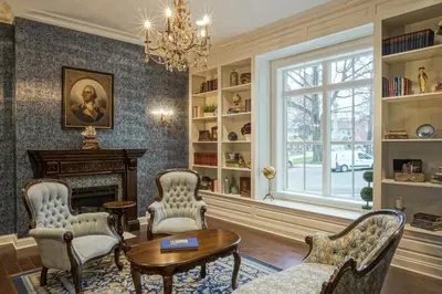 a living room with chairs and a table and a fireplace at The Mount Vernon Grand Hotel in Mount Vernon