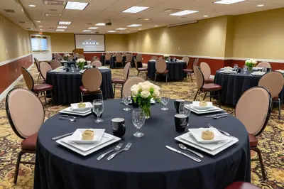 a conference room with round tables and chairs at The Mount Vernon Grand Hotel in Mount Vernon