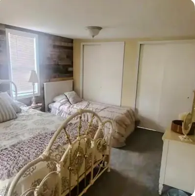 a bedroom with two beds and two windows at The Hideaway in North Canton