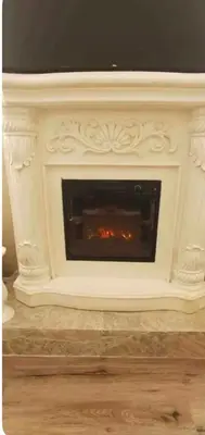 a white fireplace with a tv on top of it at The Hideaway in North Canton