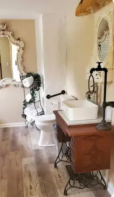 a bathroom with a white sink and a toilet at The Hideaway in North Canton