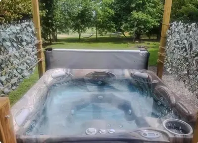 a jacuzzi tub in the middle of a yard at The Hideaway in North Canton