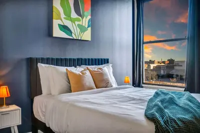 a bedroom with a large bed with a window at Fun 2Bed Apt Skeeball Foosball FREE Parking in Cleveland