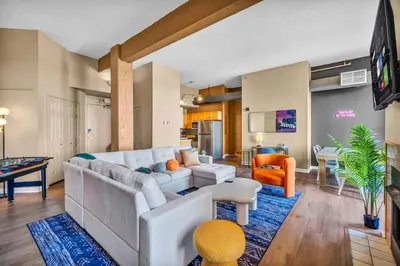 a living room with a couch and a table at Fun 2Bed Apt Skeeball Foosball FREE Parking in Cleveland