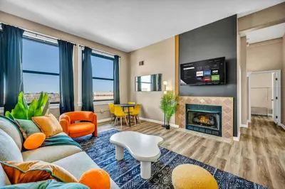 a living room with a couch and a fireplace at Funky 2B Apt in Downtown Cleveland FREE Parking in Cleveland