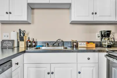 a kitchen with white cabinets and a sink at Funky 2B Apt in Downtown Cleveland FREE Parking in Cleveland
