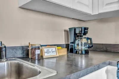 a kitchen counter with a mixer and a sink at Funky 2B Apt in Downtown Cleveland FREE Parking in Cleveland