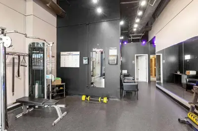 a room with a gym with a treadmill and a chair at Funky 2B Apt in Downtown Cleveland FREE Parking in Cleveland