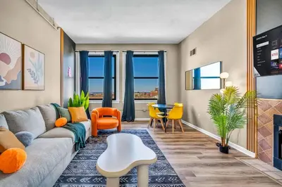 a living room with a couch and a table at Funky 2B Apt in Downtown Cleveland FREE Parking in Cleveland
