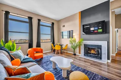 a living room with a couch and a fireplace at Colorful 2Bed Apt Heart of Downtown Lake Views in Cleveland