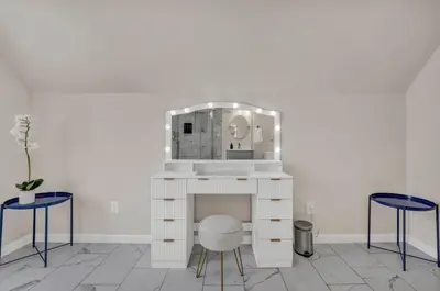 a dressing table with a mirror and two stools at BIG 4BR House 7 Mins to Downtown with Foosball and Games in Cleveland