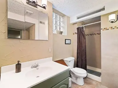 a bathroom with a white sink and a toilet at Fun 3 BR Home in Ohio City Game Room Sleeps 11 in Cleveland