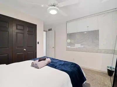a bedroom with a white bed and a window at Fun 3 BR Home in Ohio City Game Room Sleeps 11 in Cleveland