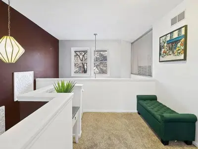 a living room with a green chair and a table at Fun 3 BR Home in Ohio City Game Room Sleeps 11 in Cleveland